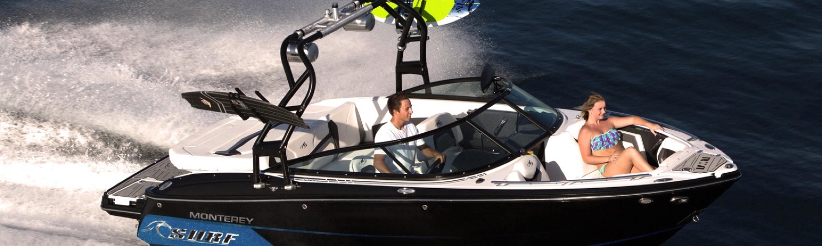 A Monterey surf boat throwing a wake